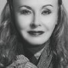 Headshot of a smiling woman in her late 40s.